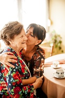Older woman and younger woman embracing