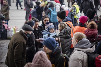A crowd of people transiting through Lviv stand outside the Lviv train station. Credit: istock.com/JoelCarillet